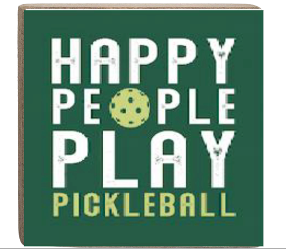 A green decorative wooden block with white text that reads 'HAPPY PEOPLE PLAY PICKLEBALL' and an illustration of a pickleball. Available at Be Charmed
