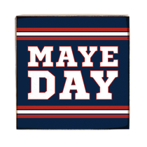 Square sign with 'MAYE DAY' text on a blue background with red and white stripes. Available at Be Charmed