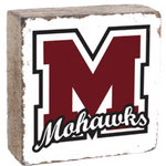 A Rusttic marlin decorative block with a white background featuring a black 'M' and the word 'MARLINS' in a script typeface, on a wooden surface. Available at Be Charmed