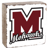 A Rusttic marlin decorative block with a white background featuring a black 'M' and the word 'MARLINS' in a script typeface, on a wooden surface. Available at Be Charmed