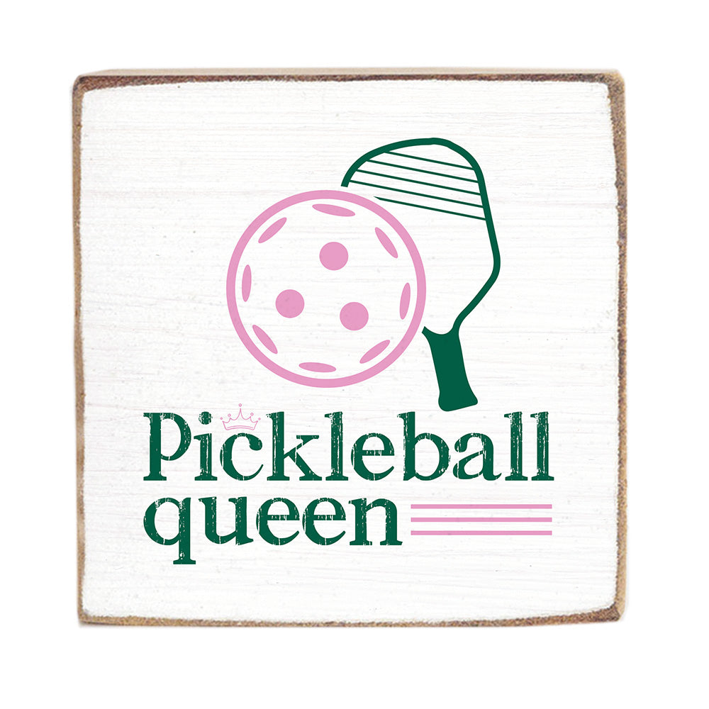A Rustic Marlin wooden block sign with a white background featuring a graphic of a pickleball and the text 'Pickleball queen'. The sign has a rustic appearance with visible wood edges.Available at e Charmed