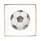 Soccer ball design on a square rustic wood block with a white background. Available at Be Charmed
