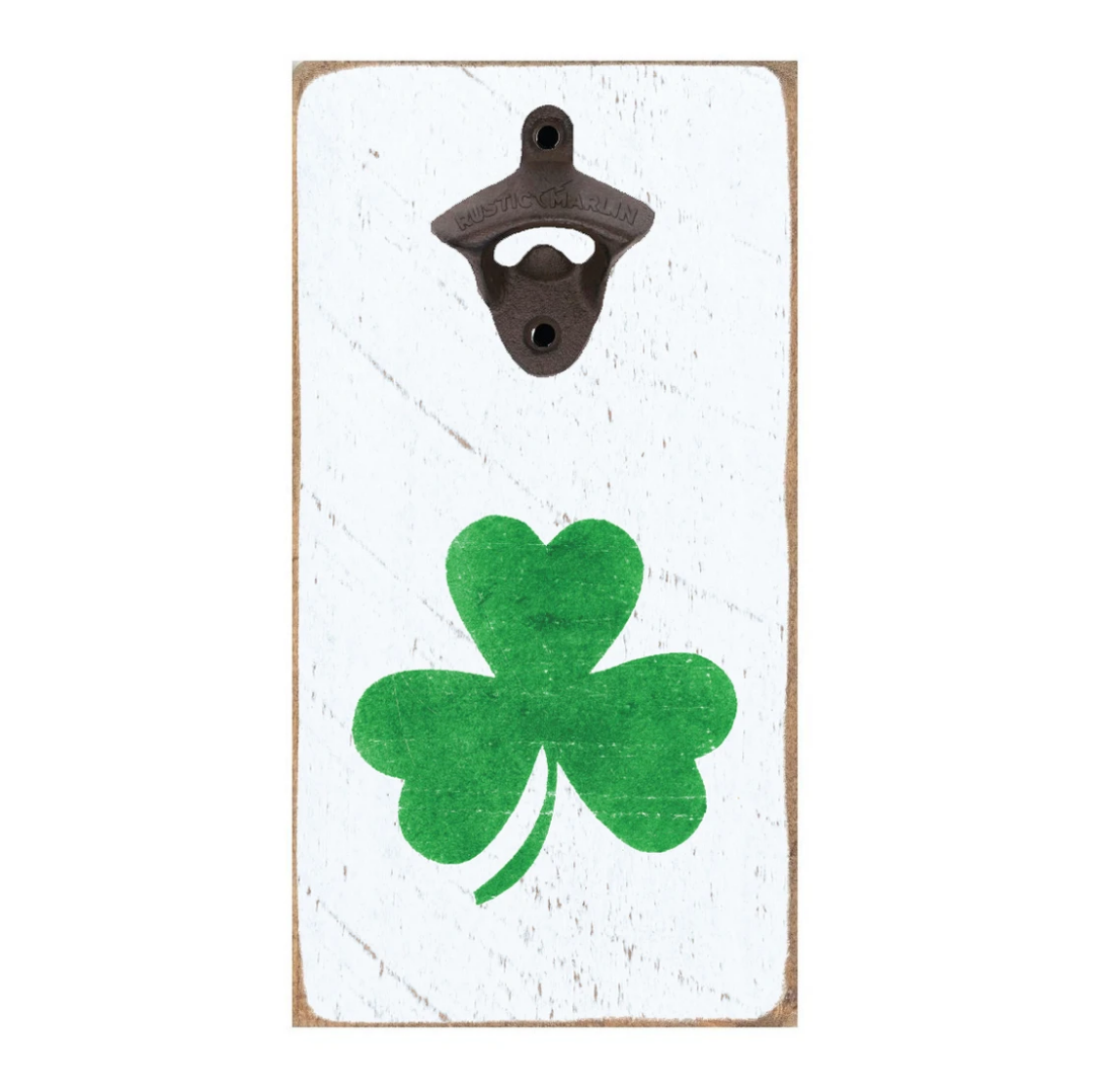 A wall-mounted, rustic style bottle opener with a shamrock design on a white background. Available at Be Charmed