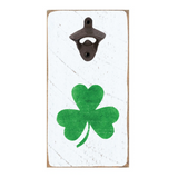 A wall-mounted, rustic style bottle opener with a shamrock design on a white background. Available at Be Charmed