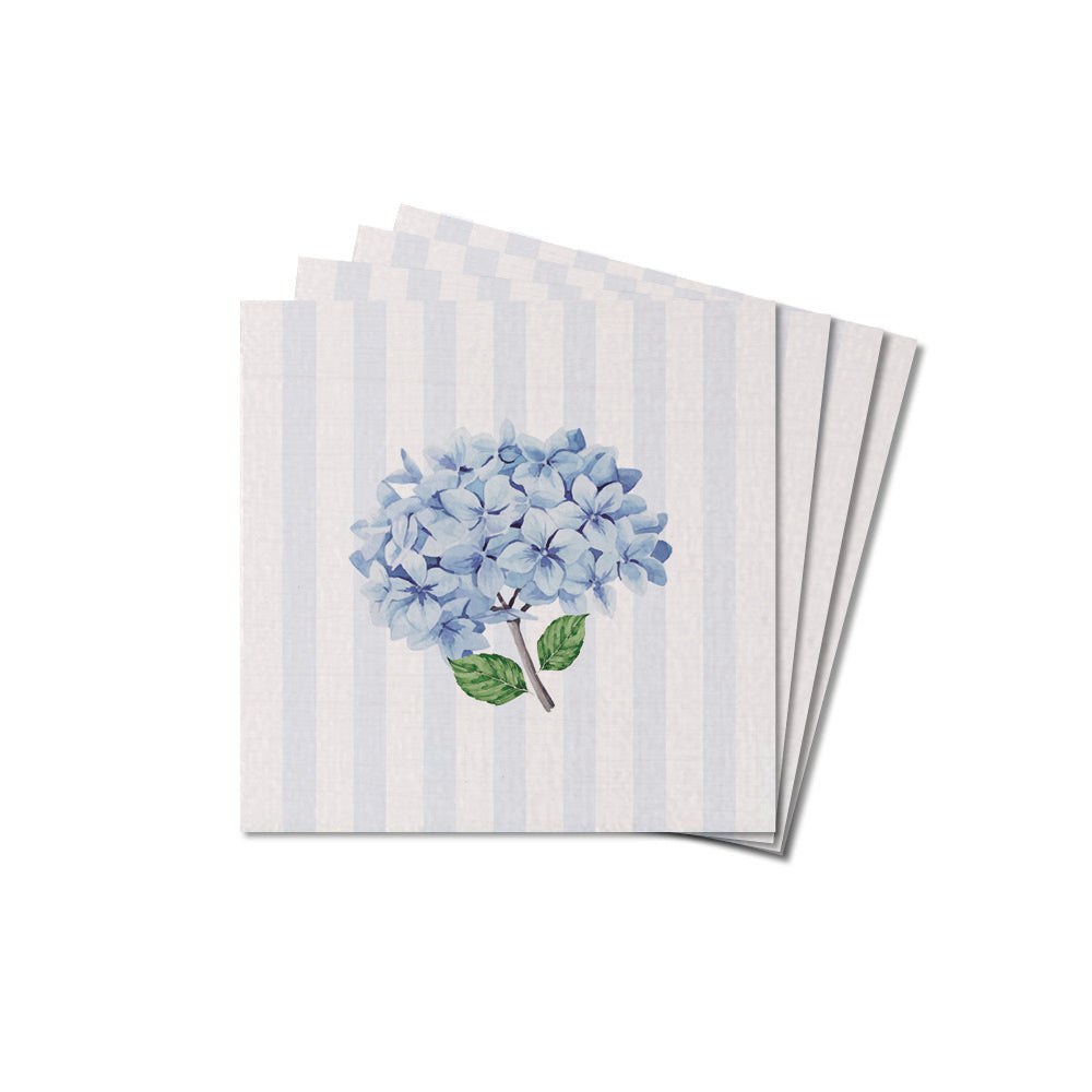 A stack of square coasters with a hydrangea floral pattern on a striped blue and white background. Available at Be Charmed