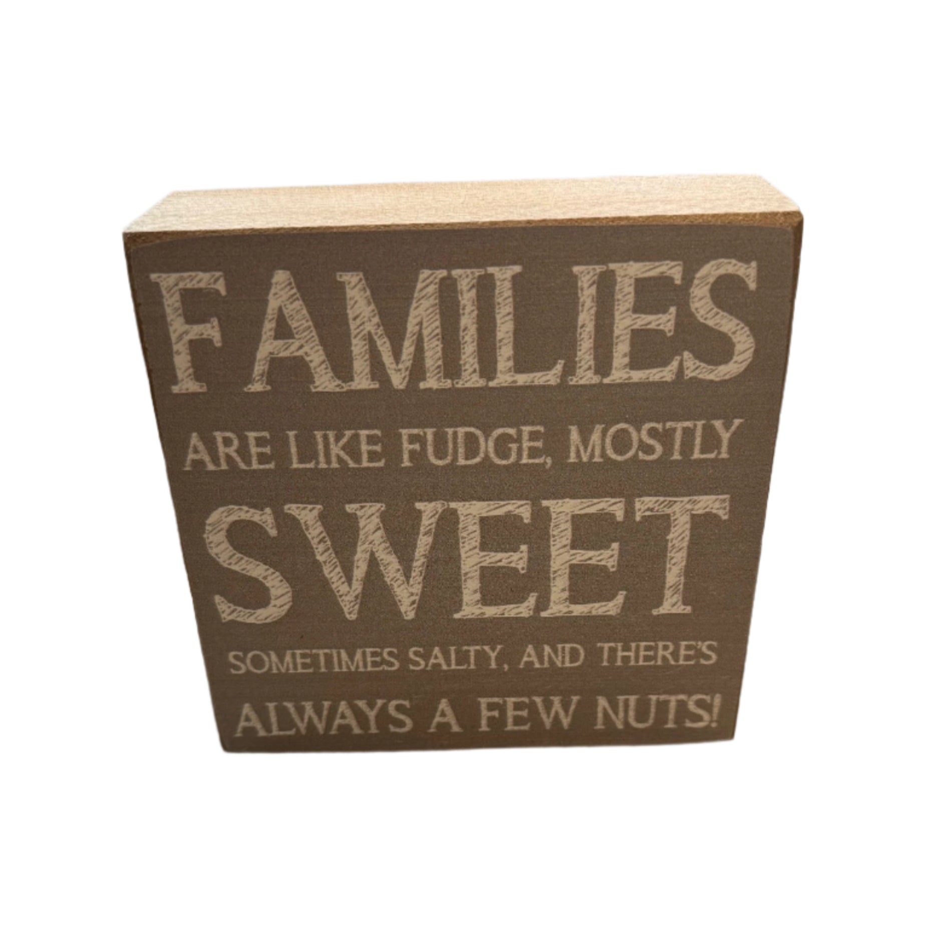 A rustic marlin decorative wooden block with the text 'FAMILIES ARE LIKE FUDGE, MOSTLY SWEET SOMETIMES SALTY, AND THERE'S ALWAYS A FEW NUTS!' printed on it. Available at Be Charmed