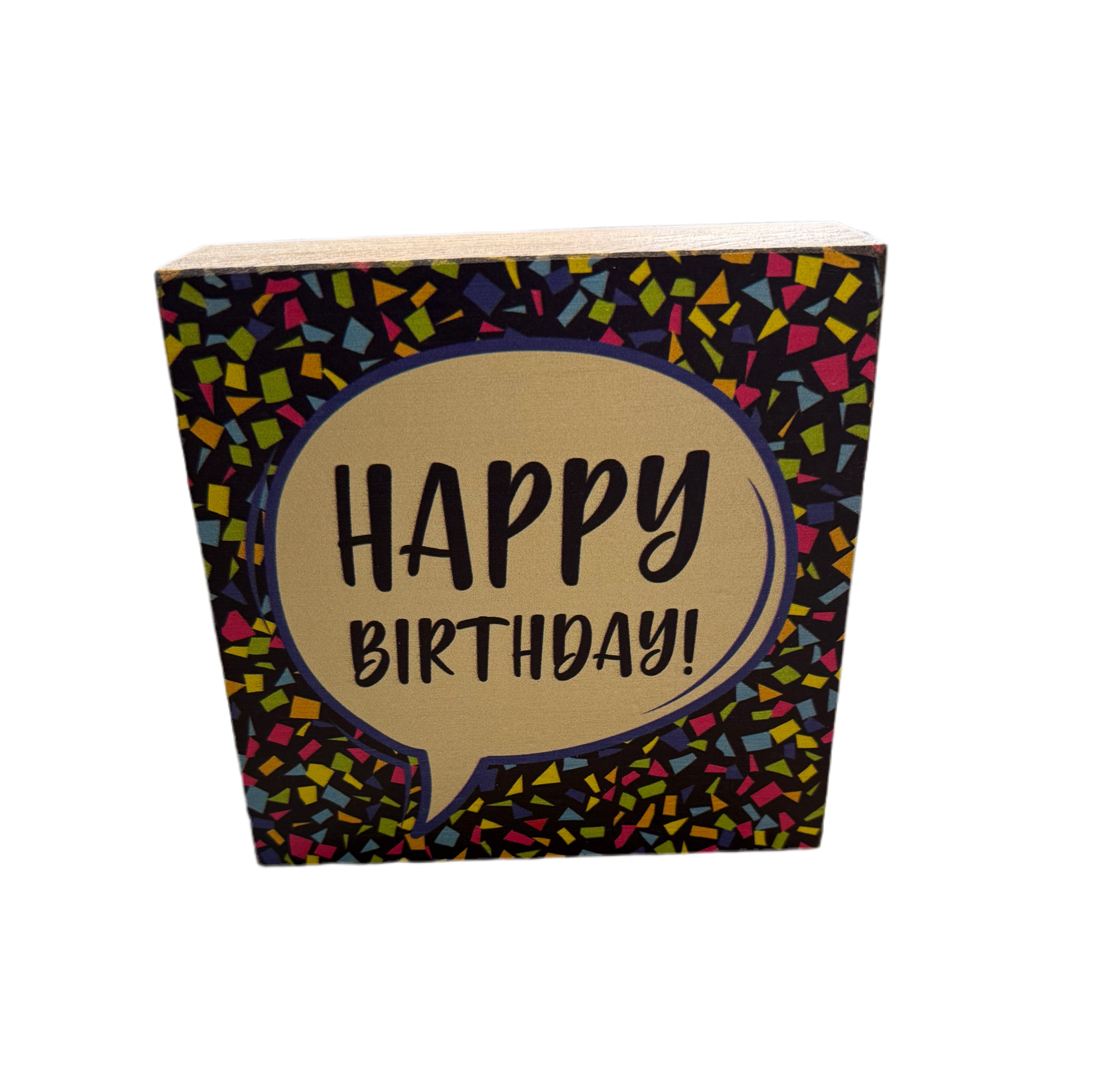 A decorative Rustic Marlin wooden block with 'HAPPY BIRTHDAY!' written in black on a beige background, surrounded by a multicolored confetti pattern. Available at Be Charmed