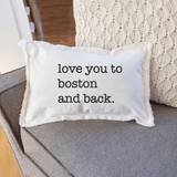 Rustic Marlin "Love You to Boston" 12x18 Pillow pictured on chair - Handcrafted in New England, this pillow adds Boston charm to any space. Available at Be Charmed Gifts.