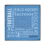 A Rustic Marlin wooden block sign with blue background and white text listing various sports, including field hockey, lacrosse, soccer, and more, along with the text 'FIELD HOCKEY lacrosse SOCCER' and 'SWIMMING golf Volleyball'. Available at Be Charmed