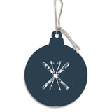 Navy blue Christmas ornament with white ski and snowflake design on a white background. Available at Be Charmed