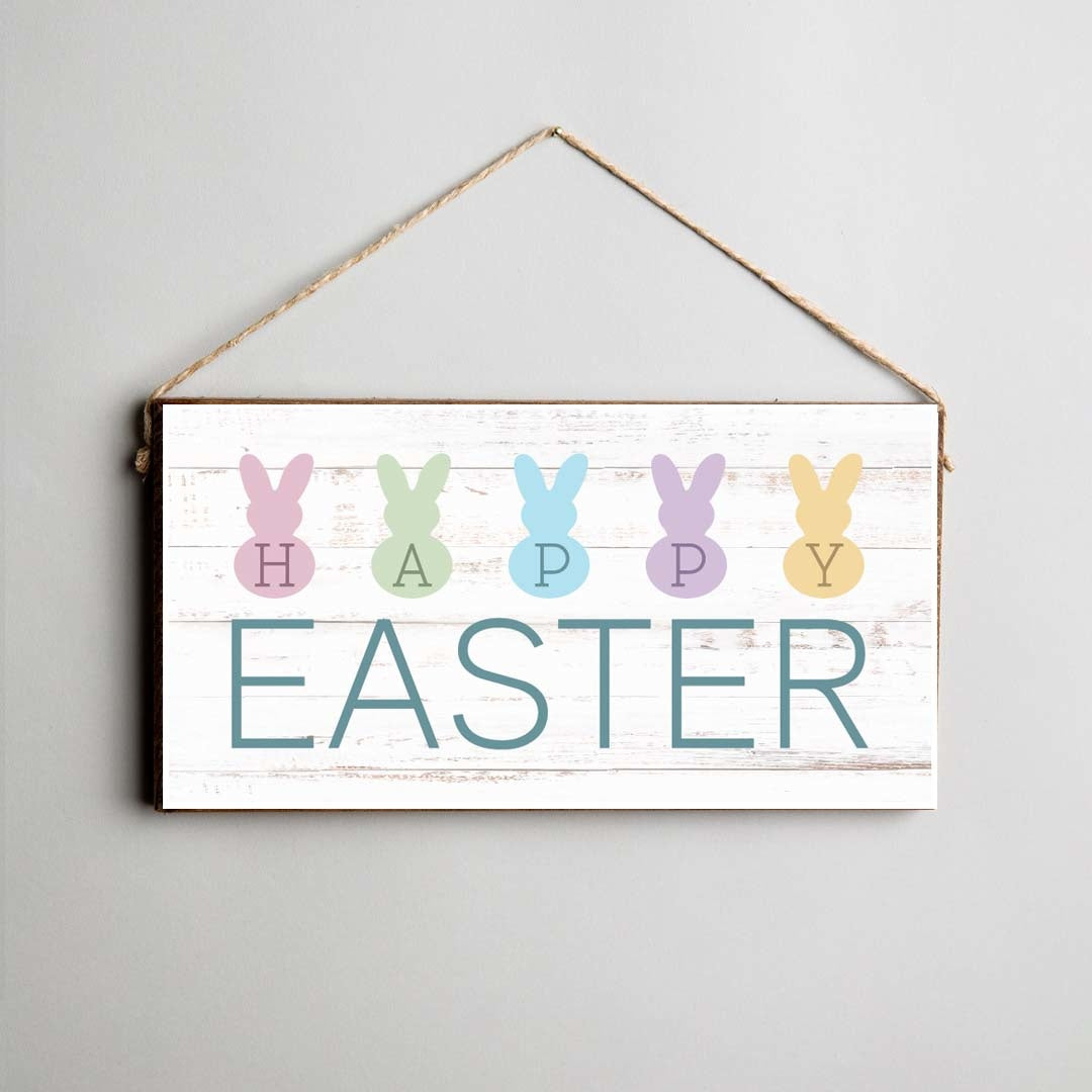 A rustic pine twine sign with 'Happy Easter' text and decorated with multi-colored bunny shapes, attached twine for hanging. Available at Be Charmed