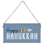 Hanging sign with 'Happy Hanukkah' text and symbols on a blue background. Available at Be Charmed