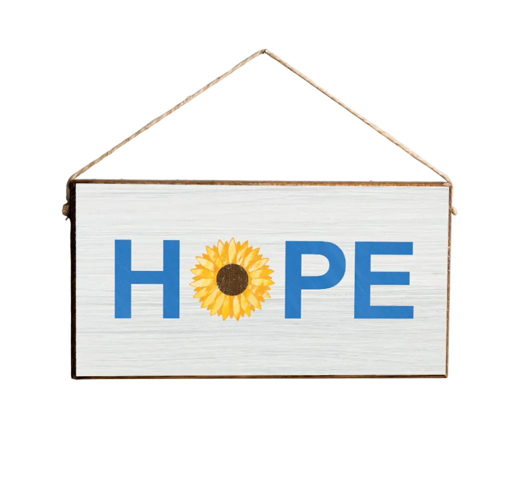 A Rustic Marlin wooden sign with a 'Hope' text and a sunflower illustration, hanging against a neutral background. Available at Be Charmed