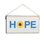 A Rustic Marlin wooden sign with a 'Hope' text and a sunflower illustration, hanging against a neutral background. Available at Be Charmed