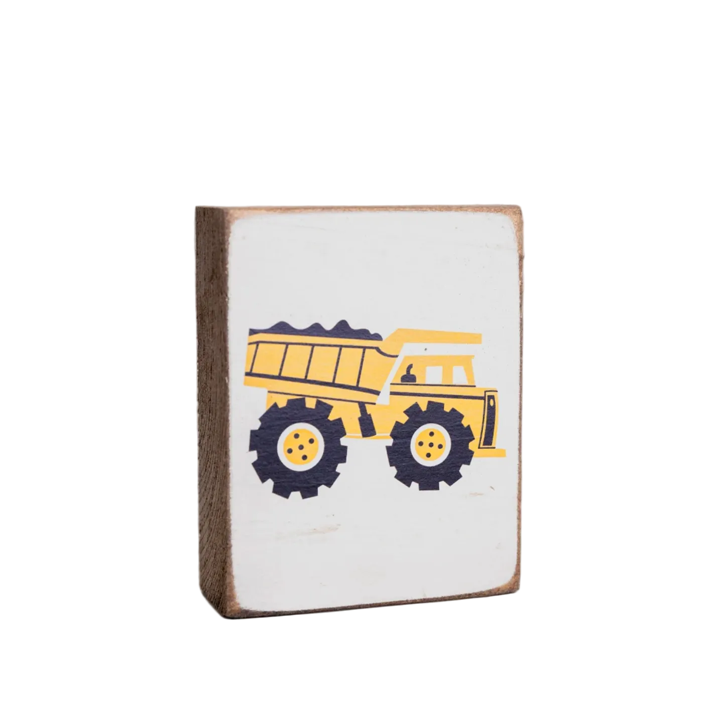 A decorative wooden block with a rustic design featuring a yellow dump truck on a white background, placed against a grey background. Available at Be Charmed