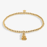 A Littles & Co Mama Bear gold bracelet featuring a delicate gold charm on a beaded band, available at Be Charmed