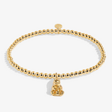 A Littles & Co Mama Bear gold bracelet featuring a delicate gold charm on a beaded band, available at Be Charmed