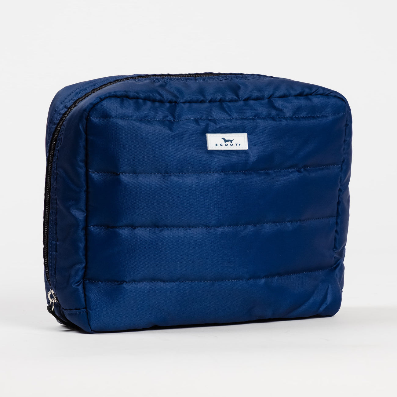 Navy Puffer Scout All Inclusive Travel Organizer – lightweight quilted toiletry bag with multiple compartments and zipper closures. Folds flat for easy packing. Available at Be Charmed.