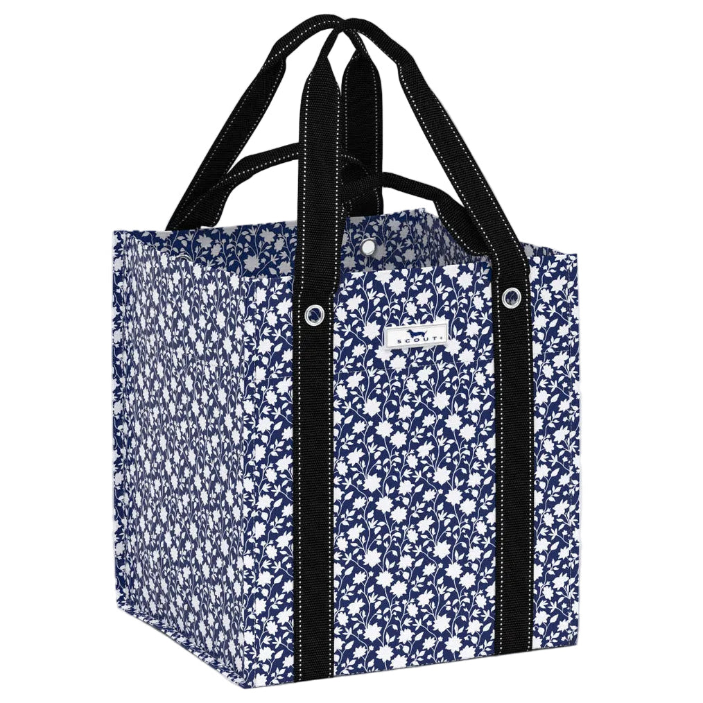 Floral-patterned tote bag with black handles on a white background. Available at Be Charmed
