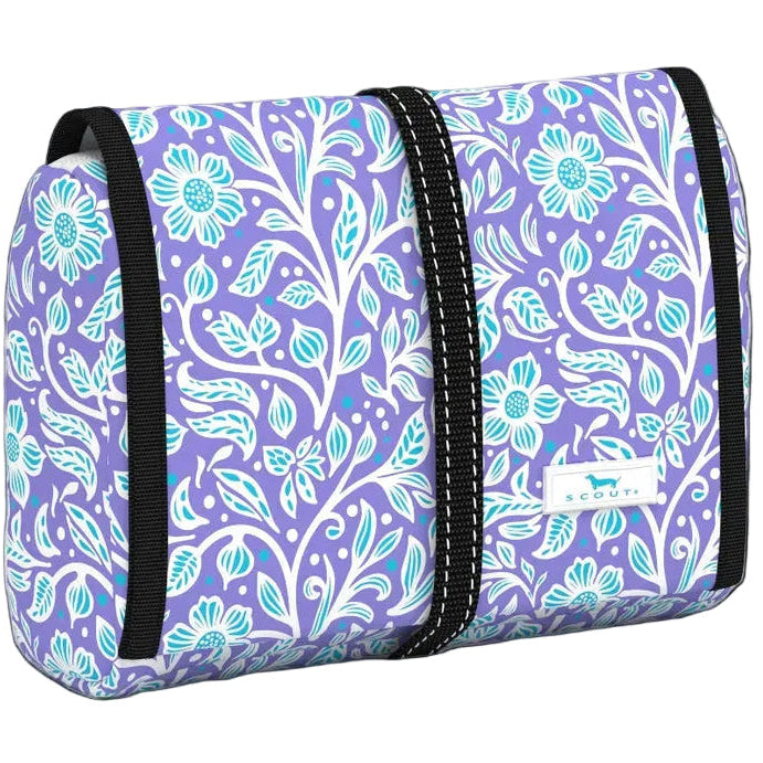 Best Buds patterned Scout Beauty Burrito toiletry bag hanging open to reveal clear organized compartments and a sturdy hook. Available at Be Charmed.