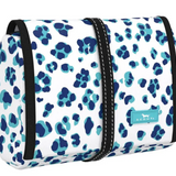 A rolled-up cosmetic or toiletry bag with a leopard print pattern on a white background, featuring a black zipper and an adjustable strap. Available at Be Charmed