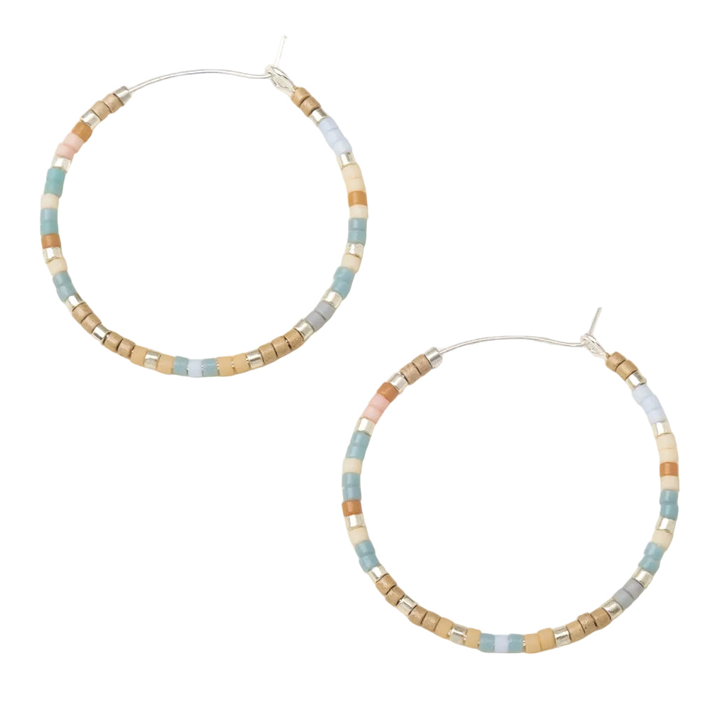 Beaded hoop earrings with pastel colors on a light background. Available at Be Charmed