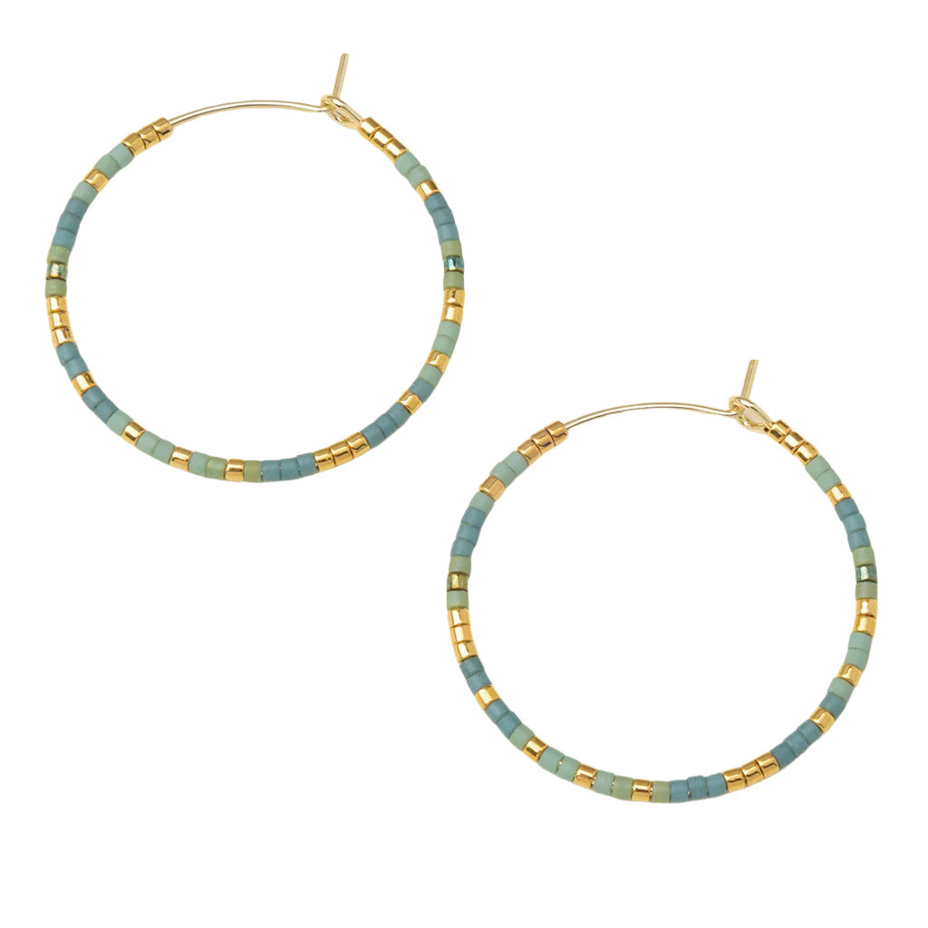 Scout Curated Wears Earrings Chromacolor Miyuki Small Hoop Turquoise Mint/Gold; A pair of gold-colored hoop earrings with turquoise mint beads mixed in, displayed against a white background. Available at Be Charmed
