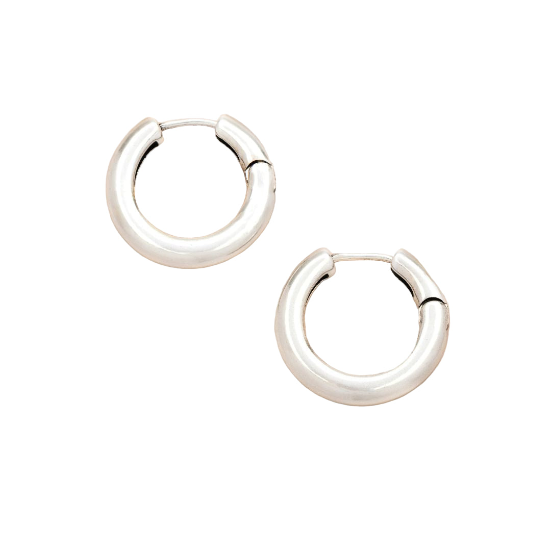 Pair of silver hoop earrings on a white background. Available at Be Charmed