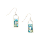 Pair of earrings with rectangular multicolored design on a beige background. Available at Be Charmed.