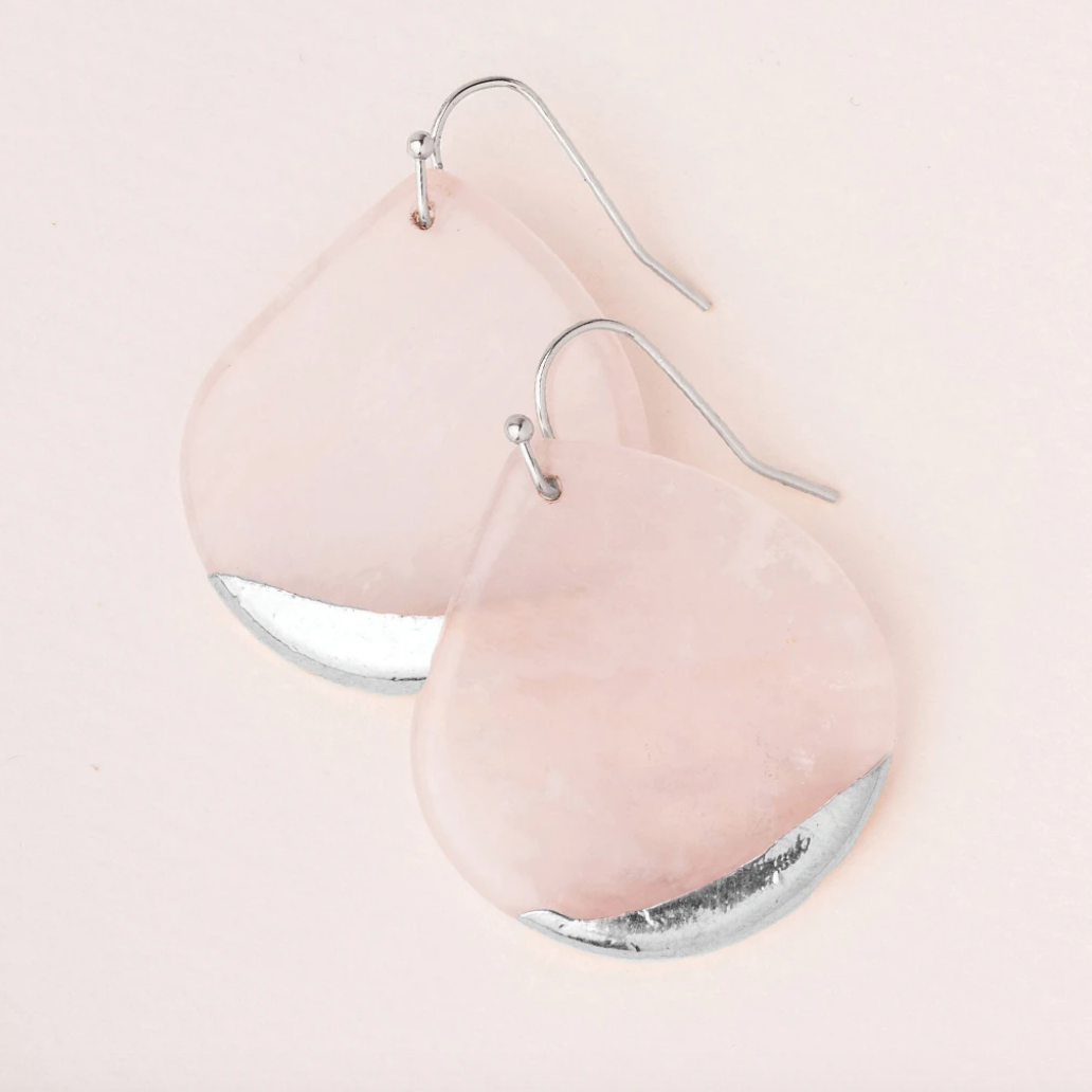 A pair of pink stone dipped teardrop earrings with silver wire on a pink background. Available at Be Charmed