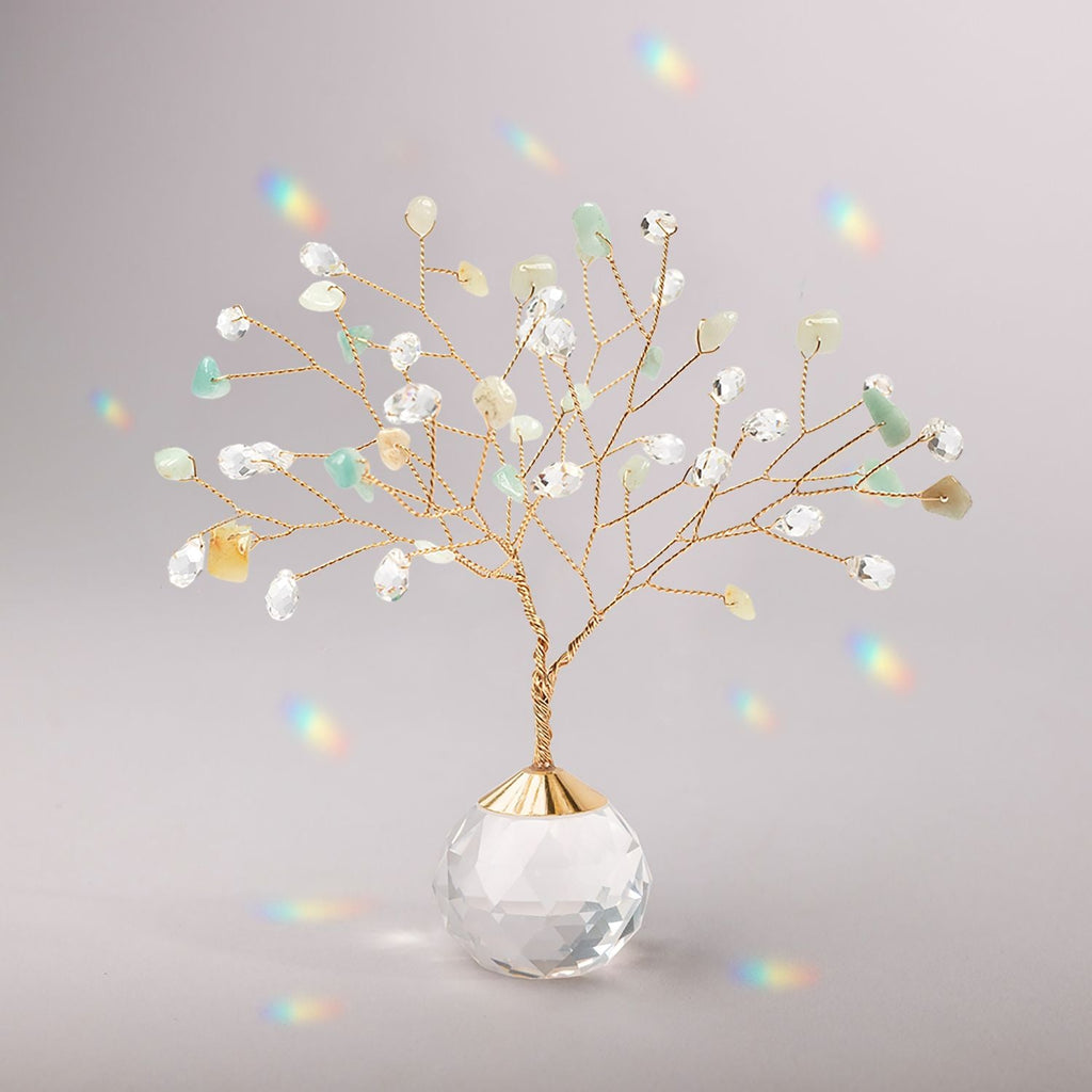 Decorative suncatcherh with colorful beads in a clear glass vase on a gray background. Available at Be Charmed