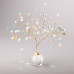 Decorative suncatcherh with colorful beads in a clear glass vase on a gray background. Available at Be Charmed