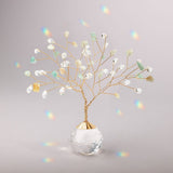 Decorative suncatcherh with colorful beads in a clear glass vase on a gray background. Available at Be Charmed