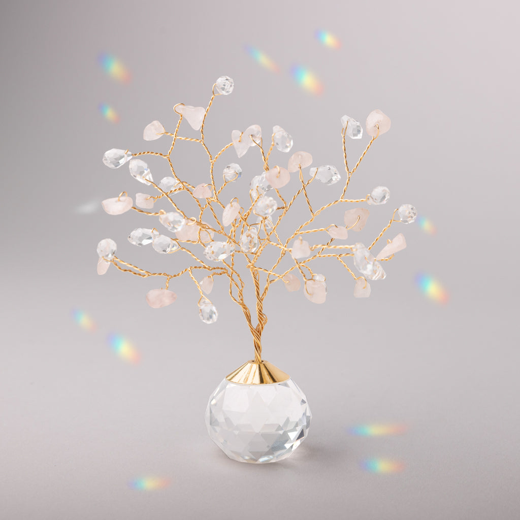Decorative suncatcher with crystals in a clear vase on a gray background. Available at Be Charmed