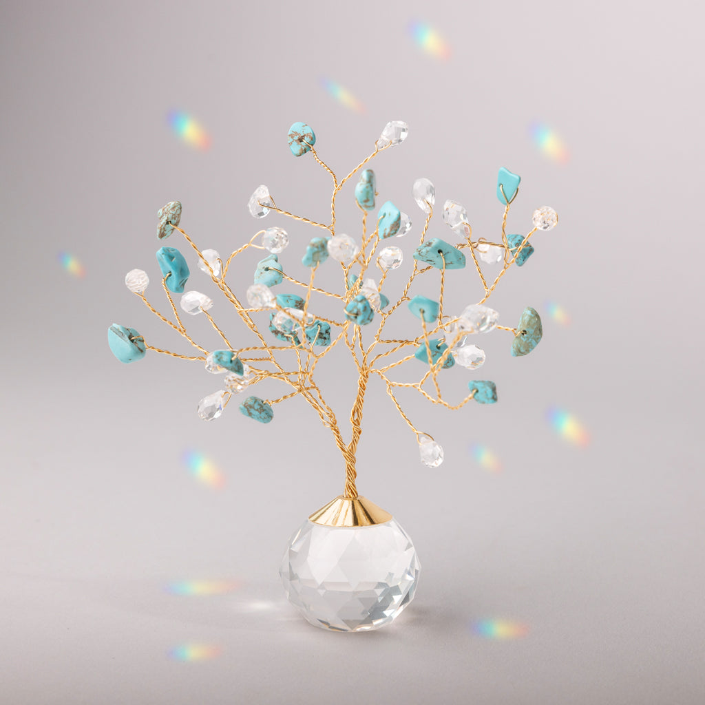 Decorative tree suncatcher with turquoise and clear beads in a clear vase on a gray background.  Available at Be Charmed