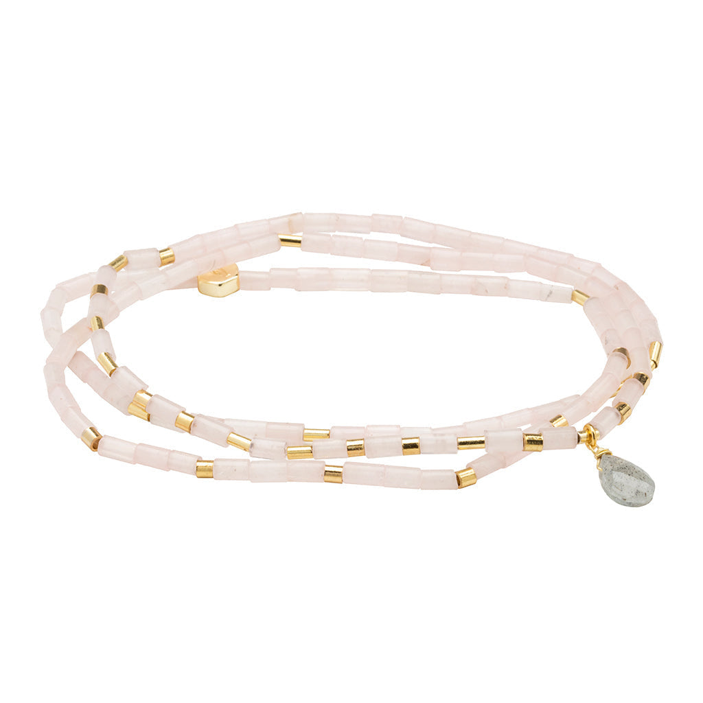 A pink semi-precious stone teardrop wrap bracelet with metallic accents and a faceted teardrop design. Available at Be Charmed