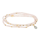A pink semi-precious stone teardrop wrap bracelet with metallic accents and a faceted teardrop design. Available at Be Charmed