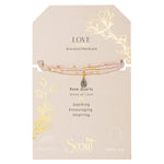 Displayed on card Teardrop Stone Wrap in Rose Quartz & Gold by Scout Curated Wears. Promotes love, self-worth, and compassion. Elegant & gift-ready. Available at Be Charmed.