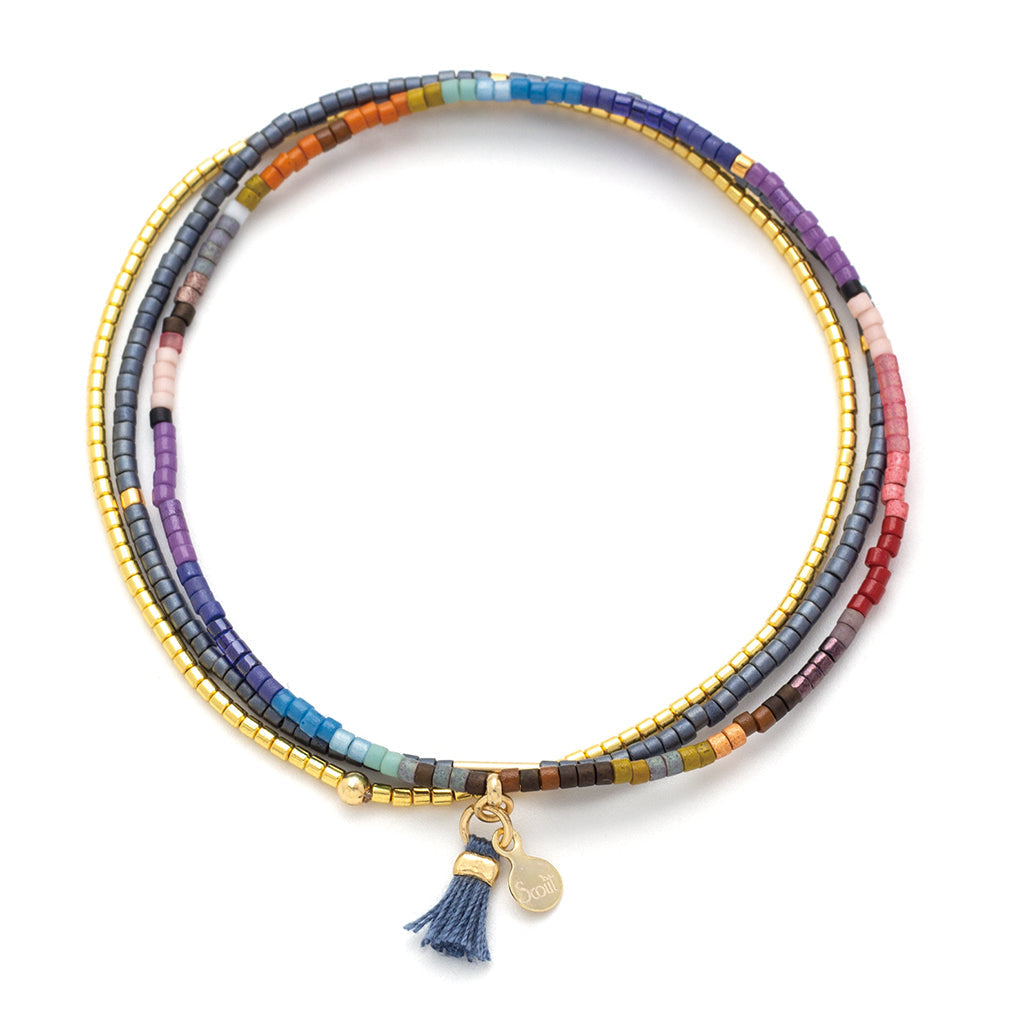 Mixed dark beaded bracelet with gold accents on a white background. Available at Be Charmed