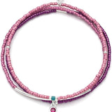 Pink beaded bracelet with silver and turquoise accents on a white background. Available at Be Charmed