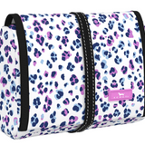 A makeup or toiletry bag with a leopard print pattern on a white background, featuring a zipper and a black strap. Available at Be Charmed
