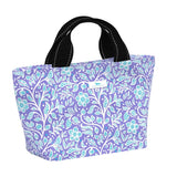 Purple floral-patterned lunch bag with black handles on a white background. Availble at Be Charmed