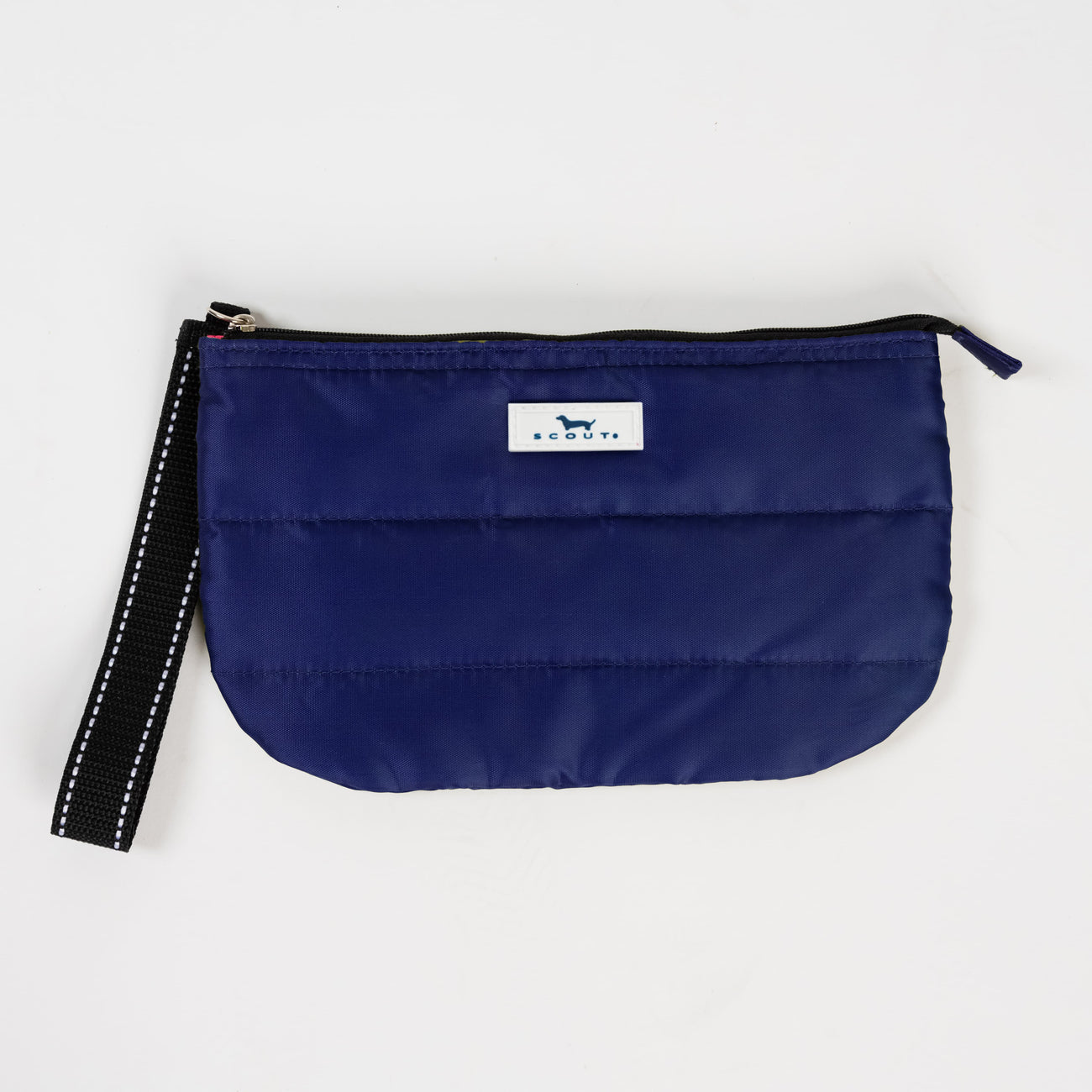 Navy Puffer SCOUT Roamy Wristlet – quilted soft pouch (9.5″ W × 6″ H × 1.25″ D) with attached wristlet strap. Lightweight and secure. Available at Be Charmed