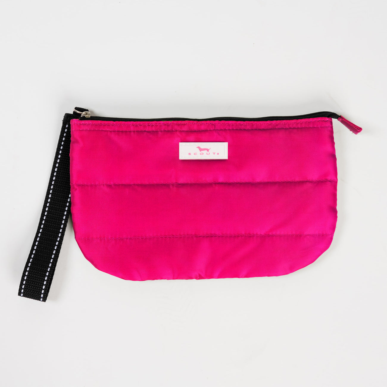 Pink Puffer SCOUT Roamy Wristlet – quilted soft pouch (9.5″ W × 6″ H × 1.25″ D) with attached wristlet strap. Lightweight and secure. Available at Be Charmed