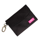 Black pouch with a pink label on a white background. Available at Be Charmed
