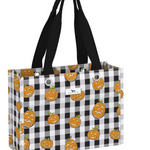A tote bag with a black and white buffalo check pattern and an all-over print of orange jack-o'-lantern pumpkins. It features two black shoulder straps and a small white brand label on the front. Available at Be Charmed