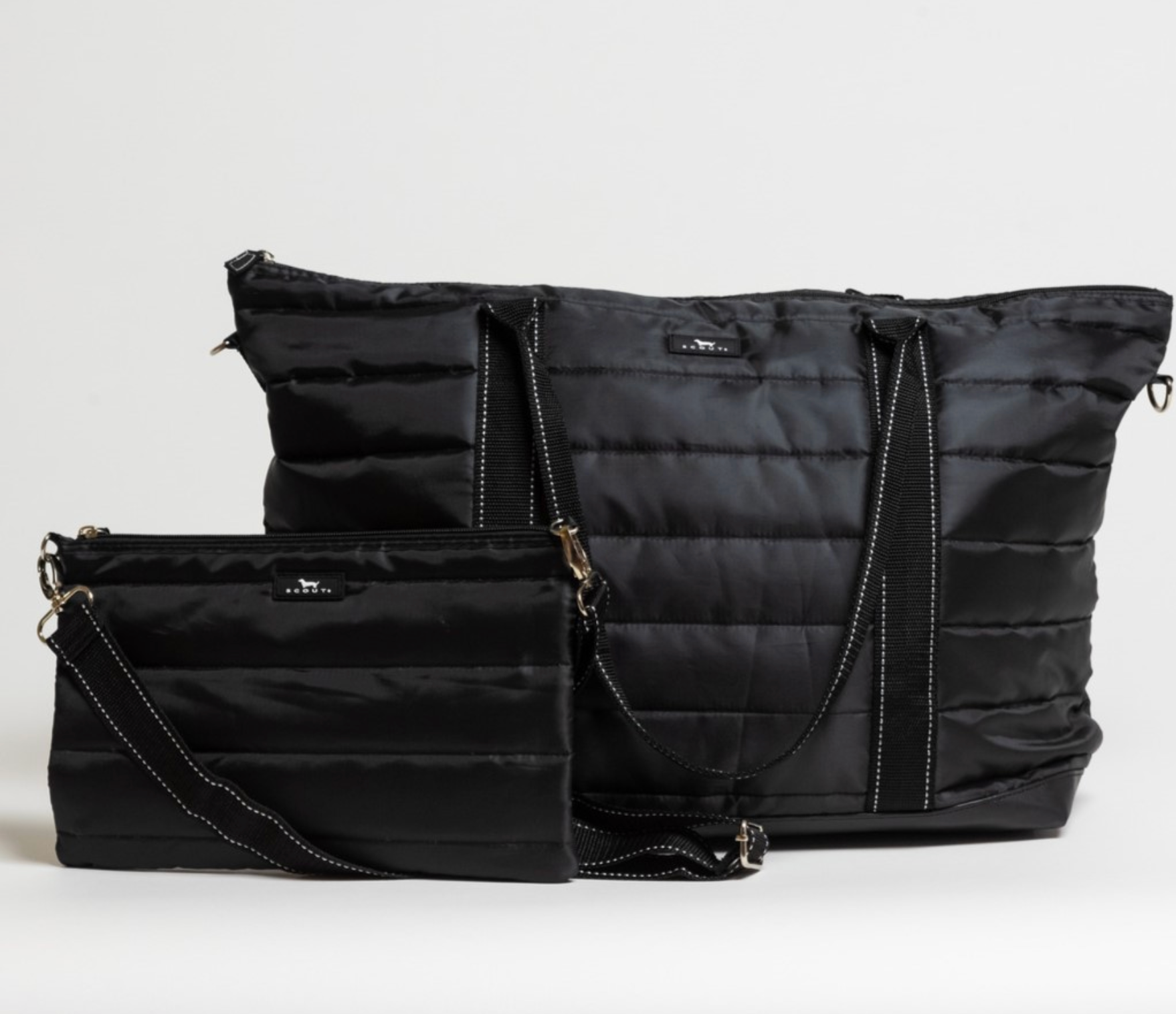 Black Puffer SCOUT Triple Advisor Travel Bag – quilted puffer 3‑in‑1 tote, removable pouch & crossbody strap. Trolley sleeve and lightweight design. Available at Be Charmed