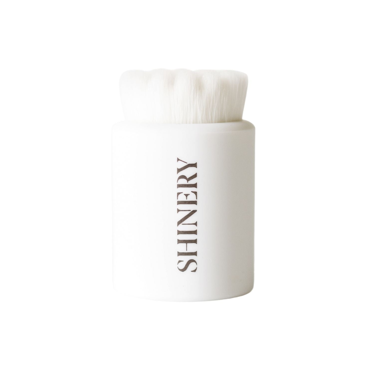 White container with a brush inside labeled 'SHINERY' on a white background. Available at Be Charmed