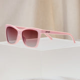 Side view of Goodr Rose Retail Therapy Sunglasses with soft rose-pink frames and polarized lenses, combining chic style and sporty comfort, perfect for shopping days, available at Be Charmed