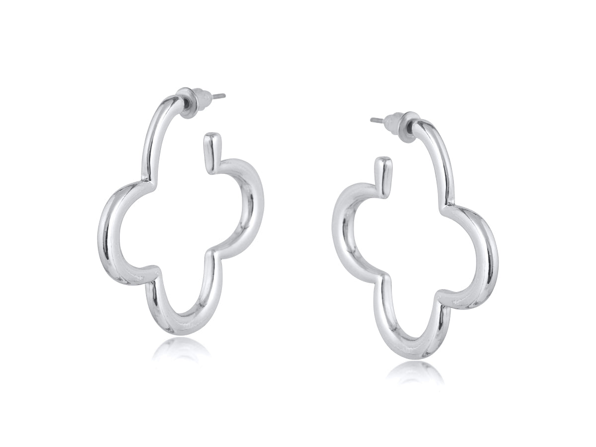 Silver Big Metal London Carmen earrings: 3.5 cm clover‑shaped floral metal hoops in radiant gold or sleek silver plating, hypoallergenic surgical steel posts, made with 50% recycled brass. Lightweight, sustainable fashion at its finest. Available at Be Charmed